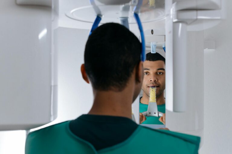 Man undergoing dental panoramic X-ray for oral health examination in a clinic.